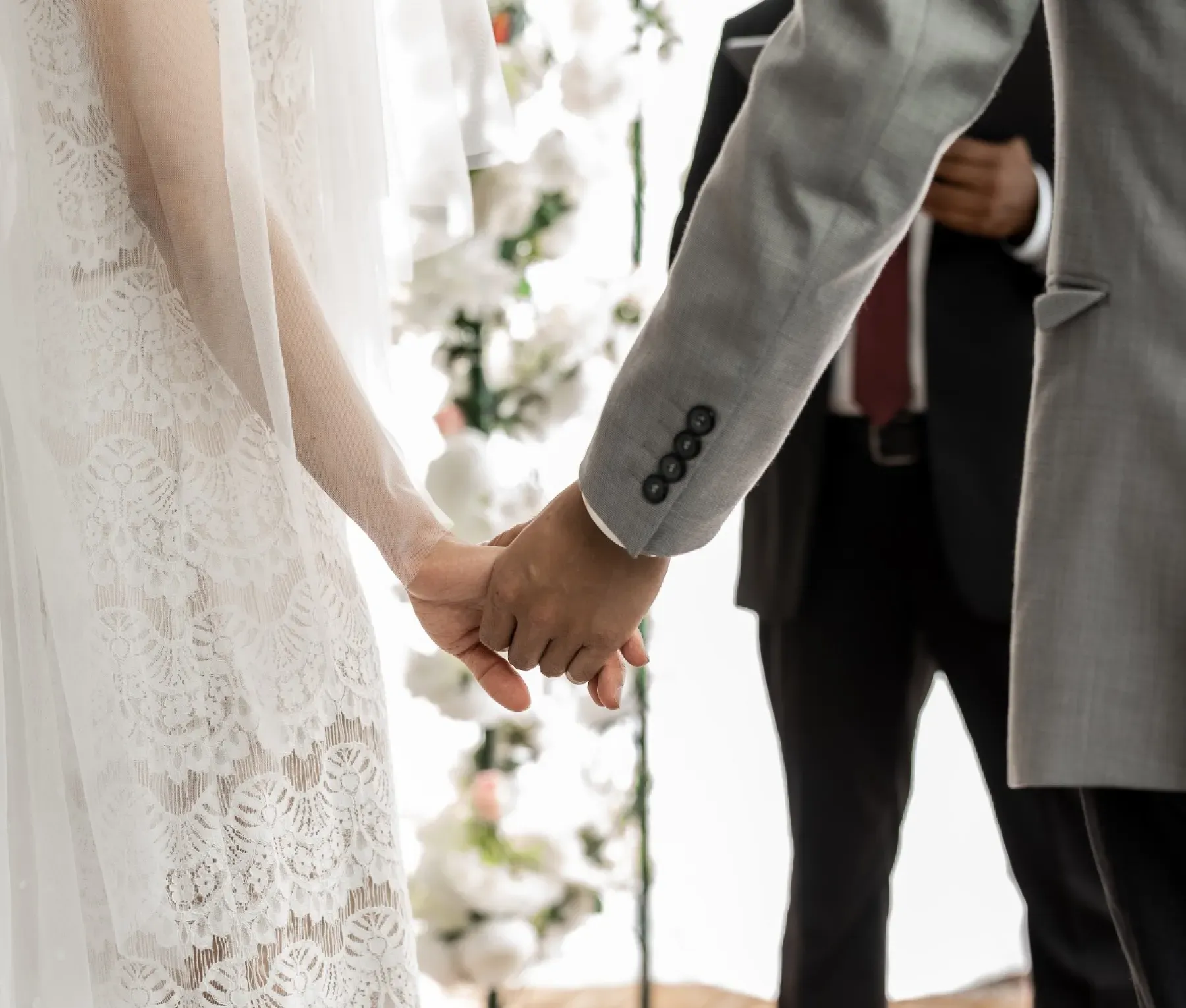 A bride adjusting her veil in a doorway