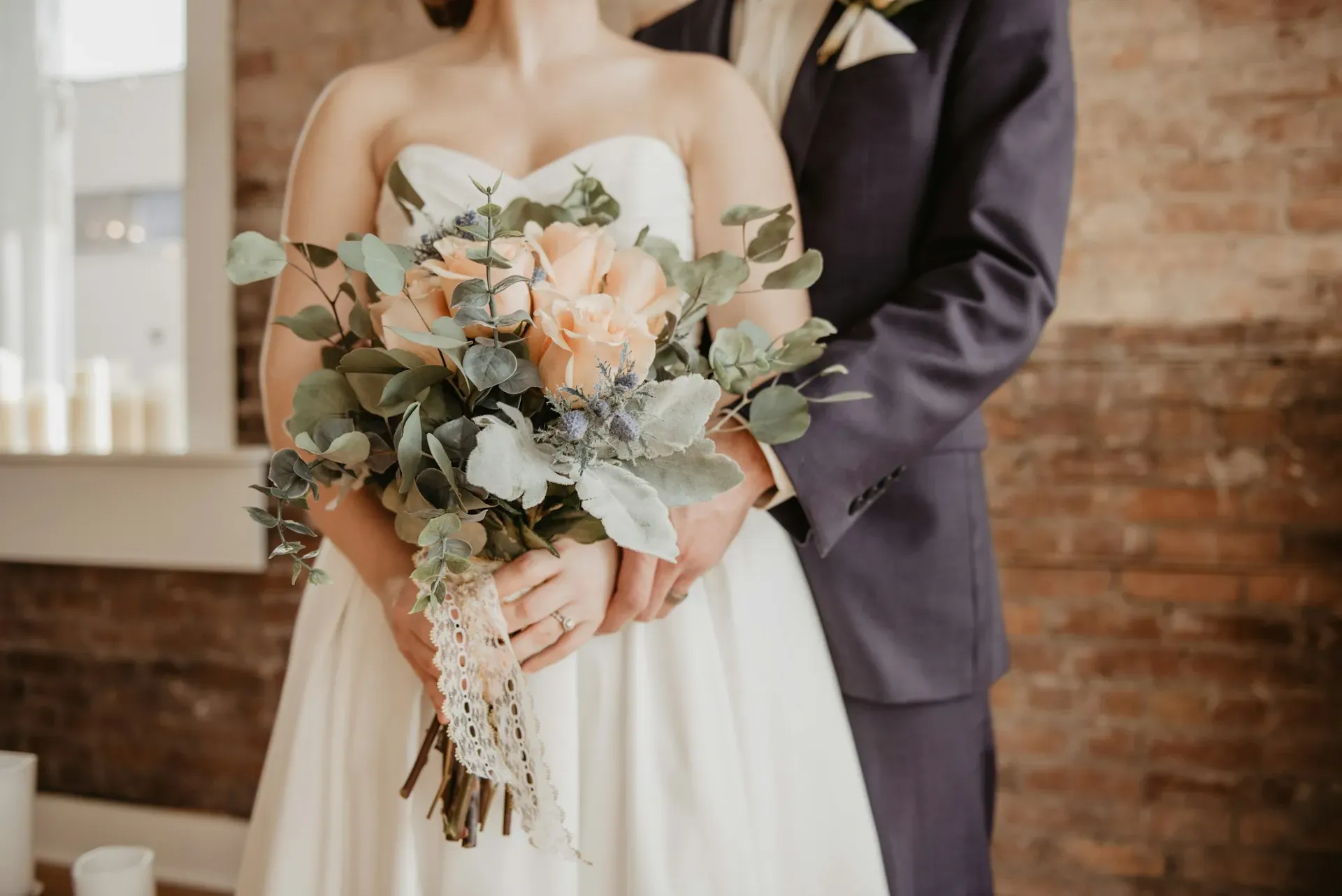 A bridesmaid fastening the back of a dress